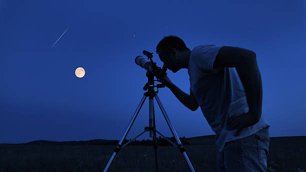 istock Amateur astronomer using telescope for watching stars, Moon, planets and other celestial objects from a field in nature. 2233650706