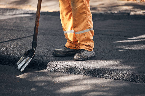 istock Construction worker working on a new asphalt layer on a public street. 2233650986