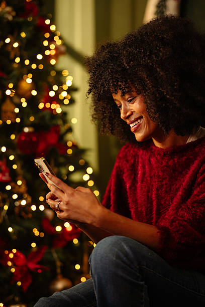 istock Young Woman Enjoying Festive Holiday Messaging 2233651126