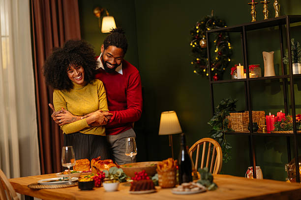 istock Couple Embracing in Festive Dining Room Setting 2233651168