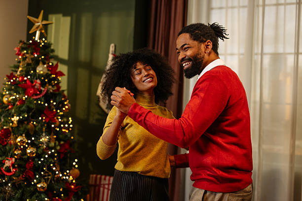 istock Happy Couple Dancing by Christmas Tree 2233651187