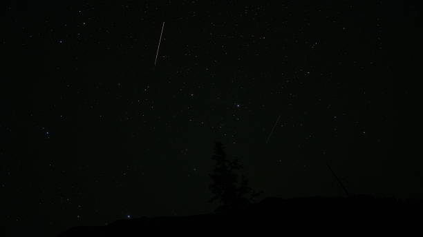 istock Bright shooting star streaking across dark night sky 2233652607