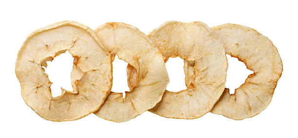 Dried apple chips cut out on a white. Top view