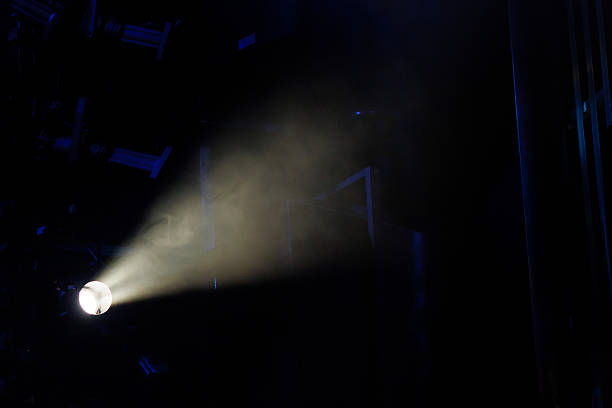 istock spotlight beam illuminates dark space with smoke in the air 2233654147