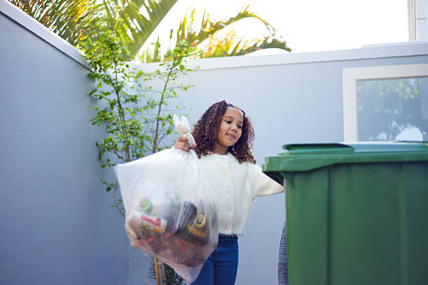 istock Girl Taking Out the Trash and Recycling 2233654561