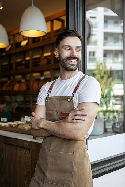 istock Male bakery owner smiling and posing for camera 2233654572