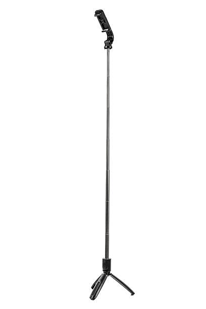 istock A sleek, black tabletop mini tripod with an attached phone holder. 2233654728