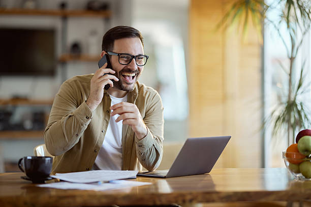 istock Happy businessman having a phone call while working at home office. 2233656671