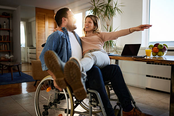 istock Happy disabled man having fun with his girlfriend at home. 2233657049