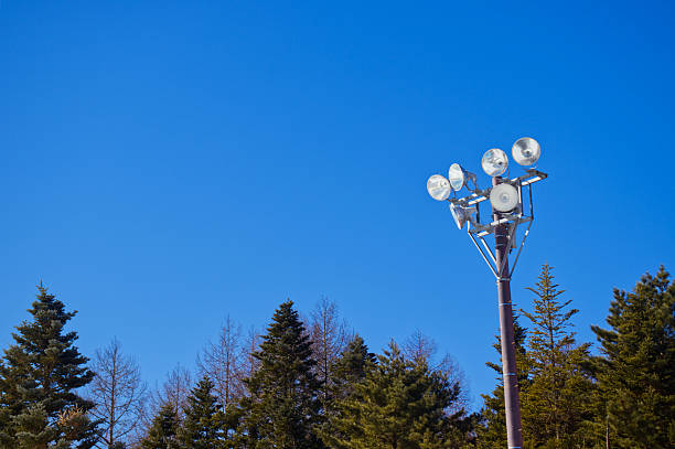 istock A tall floodlight pole standing above pine trees under a clear blue sky at the snow park in Fujiten Snow Resort 2233658173