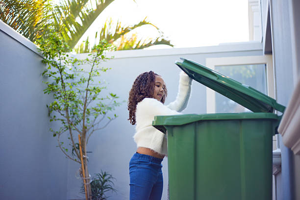 istock Girl Taking Out the Trash and Recycling 2233659638