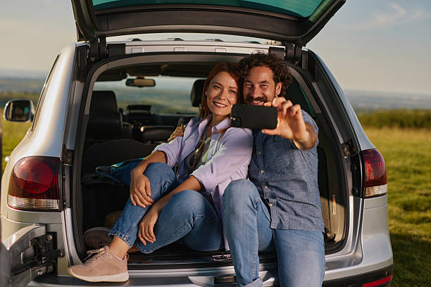 istock Happy couple taking a selfie during a road trip picnic 2233660705