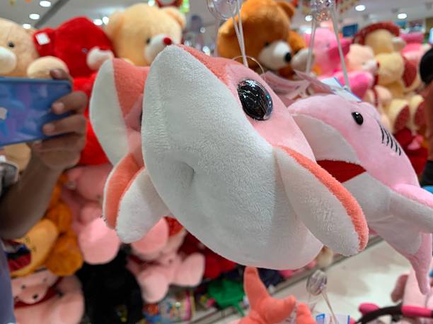 Pink and White Dolphin Plush Toy in Toy Store Display
