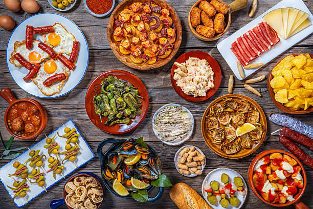 istock Assorted Spanish tapas and pintxos spread on a rustic wooden table 2233665528