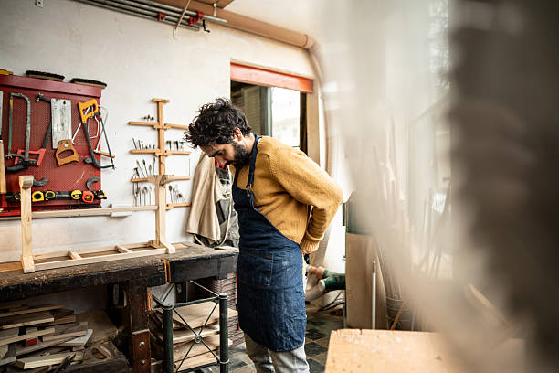 istock Mature carpenter wearing apron in a workshop 2233665574