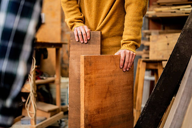 Close-up of a carpenter arranging woods in a workshop