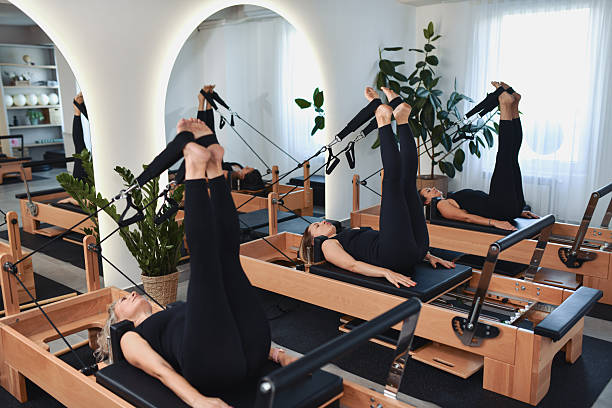 istock Class Of Women Engaged In Reformer Pilates Training Session 2233666895