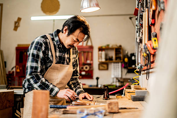 istock Mature carpenter measuring wood in a workshop 2233667116