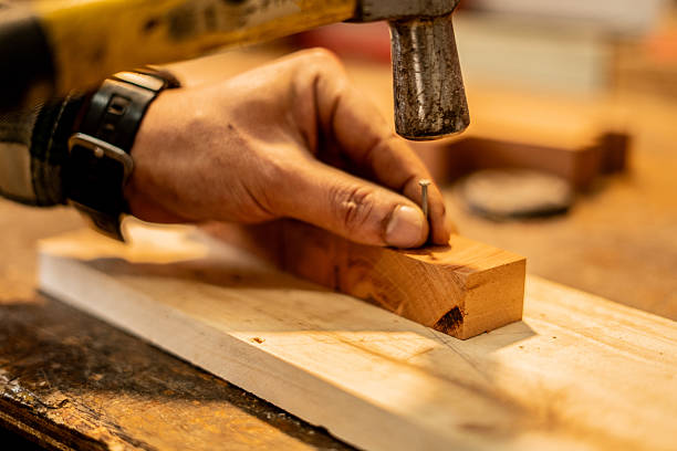 istock Close-up of a carpenter working with a hammer in a workshop 2233667172