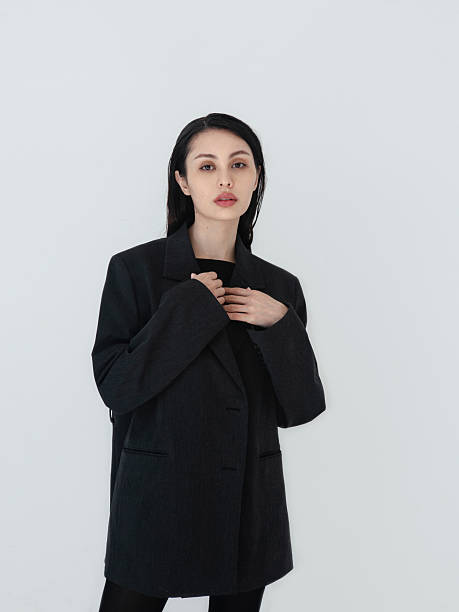 istock Amazingly beautiful young woman wearing elegant dark grey, almost black oversized Blazer Fashion model studio portrait on light white background Brunette beauty Stunning mixed Asian Caucasian girl Pretty lady 2233669521