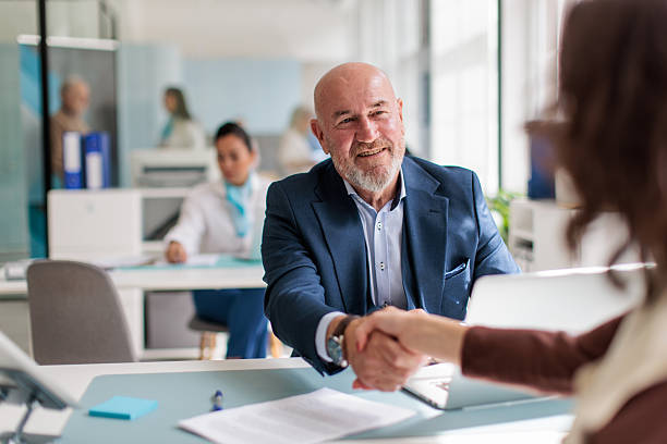 istock Banker and Female Client Finalizing Agreement at Bank Branch 2233669616