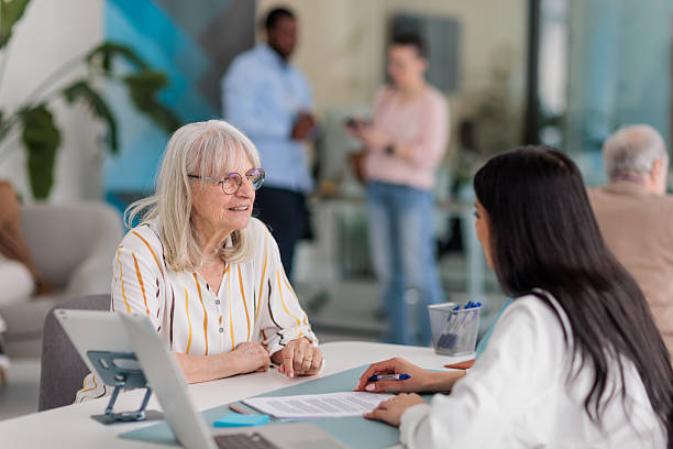 istock Banker Consulting with Female Client at Desk 2233670100