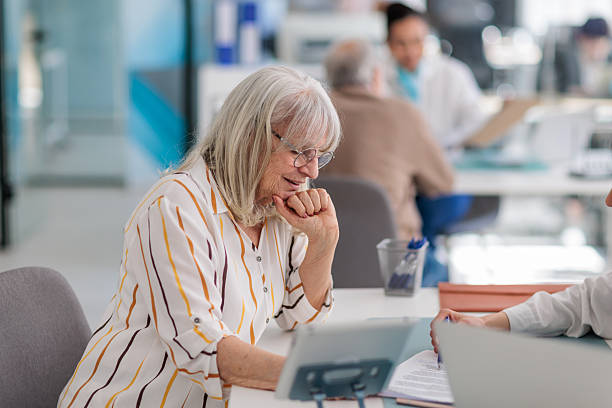 istock Banker Consulting with Female Client at Desk 2233670155