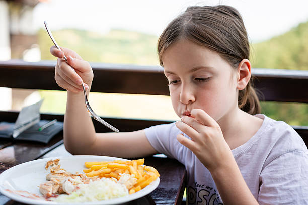 istock Girl eating a meal at the table 2233670174