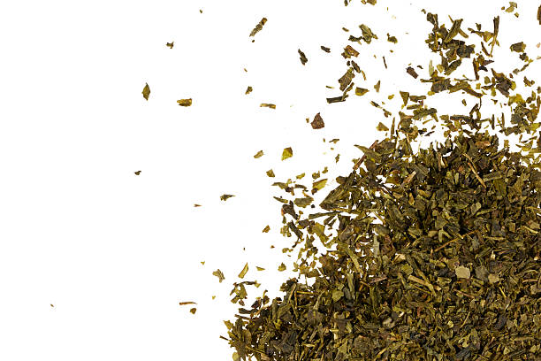 istock dried green tea leaves heap isolated on white 2233670191