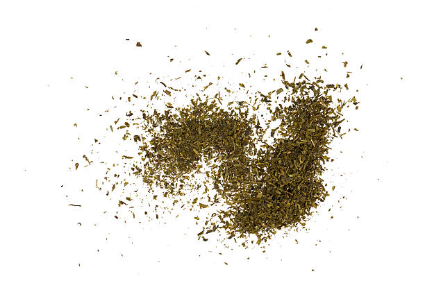 istock dried green tea leaves heap isolated on white 2233670193