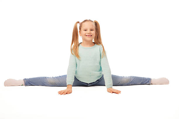 istock Smiling girl doing splits on white background 2233670306