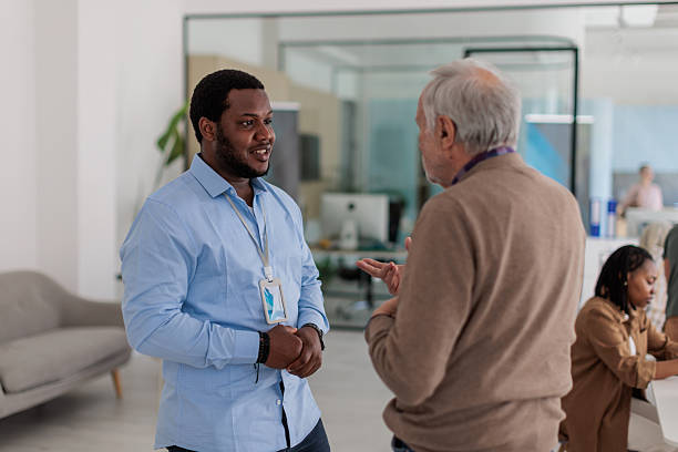 istock Professional Banker Assisting Elderly Client Inside Bank 2233670407