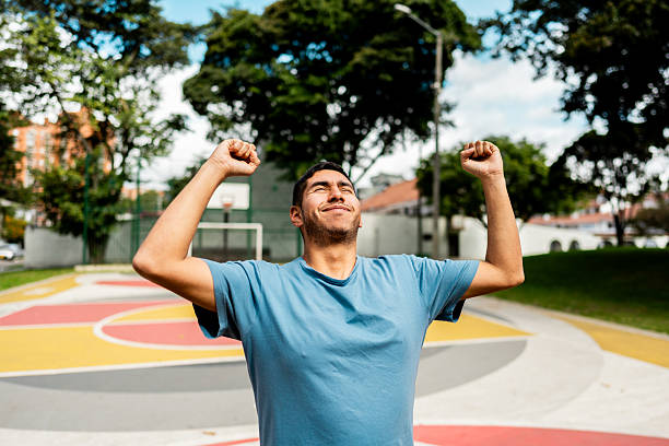 istock Young man celebrating on sport venue 2233672162