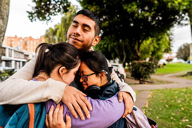 istock Friends embracing on the public park 2233673001