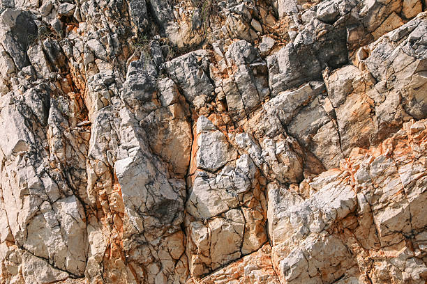istock Rough natural stone surface with fine cracks and warm earthy tones, ideal for use as a background, in geology projects, mineral displays, or nature-inspired designs. 2233673870