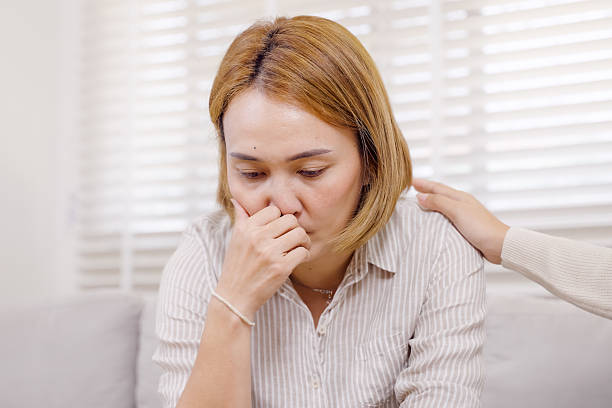 istock Asian single mother sitting in therapy room looking overwhelmed during counseling session about child with ADHD while psychologist offers comforting touch in private psychological clinic 2233676601