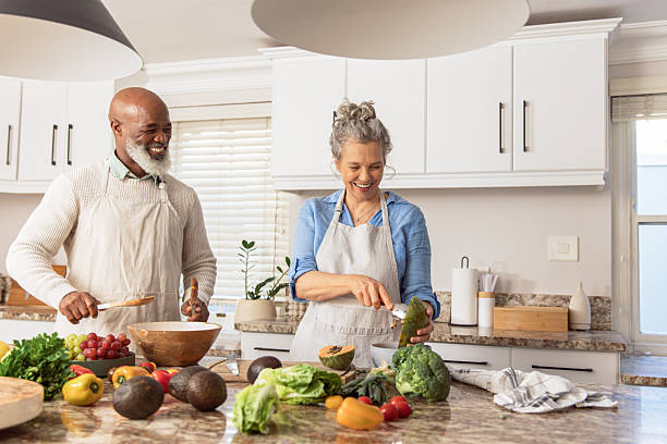 istock Mature Couple Making Healthy Salad Together in Kitchen 2233676733