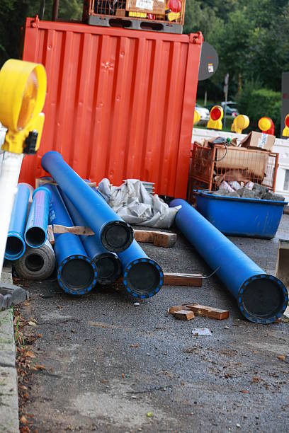 istock Pile of blue pipes and a red container 2233676922