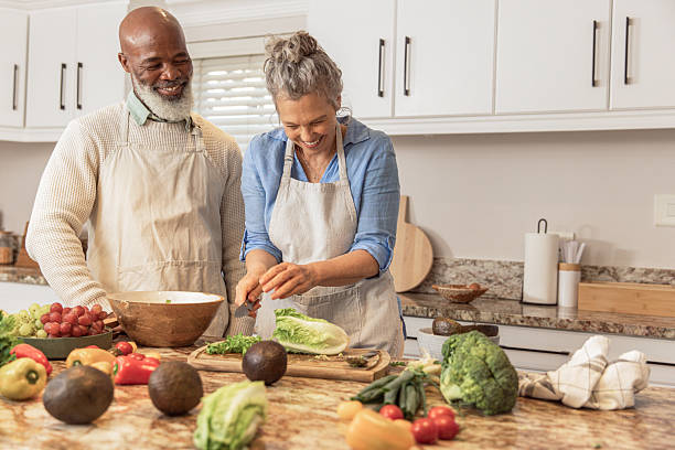 istock Mature Couple Making Healthy Salad Together in Kitchen 2233677169