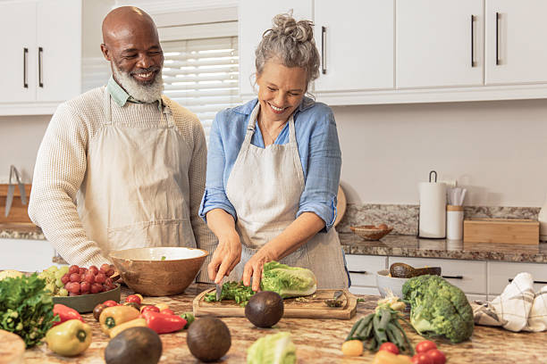 istock Mature Couple Making Healthy Salad Together in Kitchen 2233677193