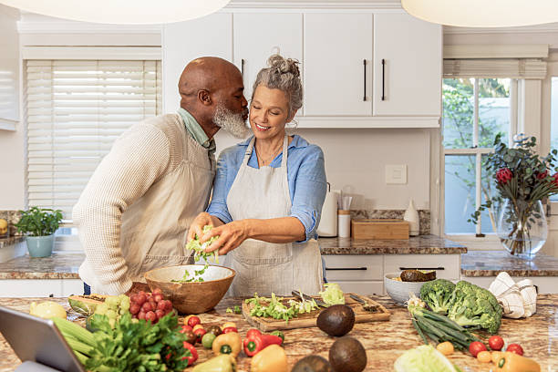 istock Mature Couple Making Healthy Salad Together in Kitchen 2233677229