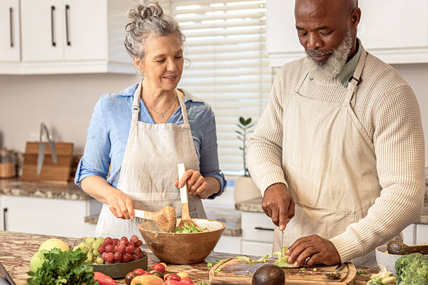 istock Mature Couple Making Healthy Salad Together in Kitchen 2233677483