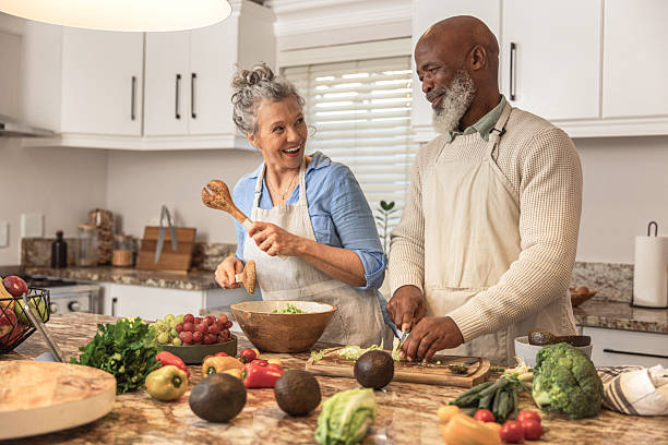 istock Mature Couple Making Healthy Salad Together in Kitchen 2233677484