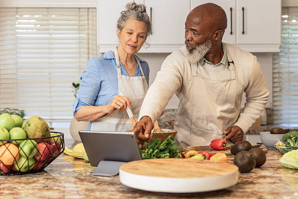 istock Mature Couple Making Healthy Salad Together in Kitchen 2233677537
