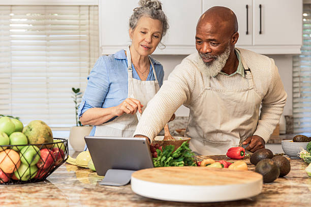 istock Mature Couple Making Healthy Salad Together in Kitchen 2233677538