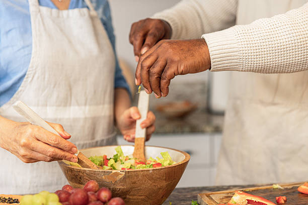 istock Close-Up of Hands Preparing Fresh Salad 2233677730
