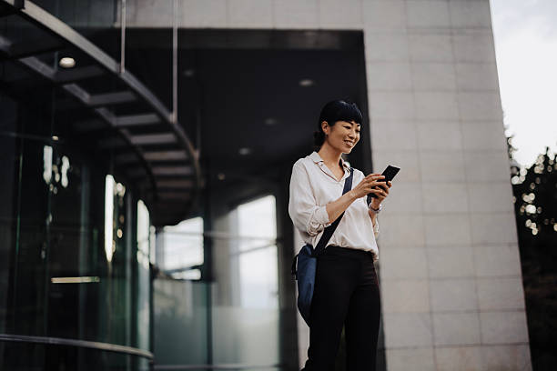 istock Japanese Businesswoman Using Smartphone While Commuting to Work 2233677925