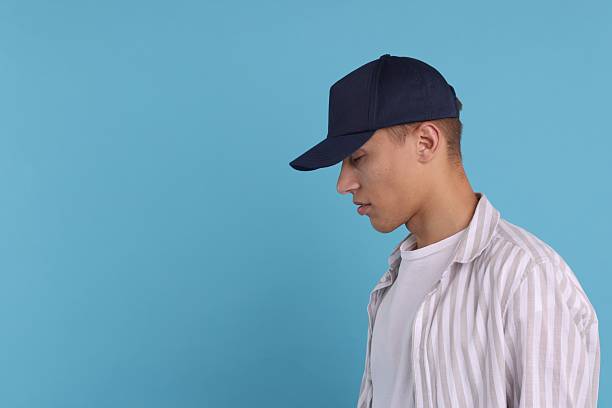 istock Man in stylish baseball cap on light blue background. Mockup for design 2233678234
