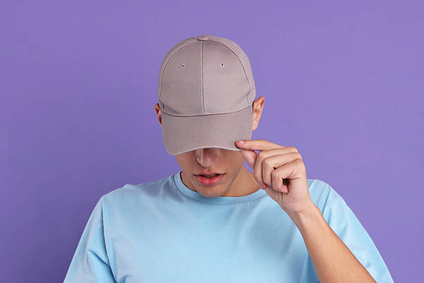 istock Man in stylish baseball cap on violet background. Mockup for design 2233678291