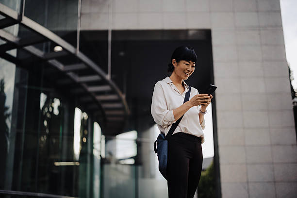istock Japanese Businesswoman Using Smartphone While Commuting to Work 2233678375
